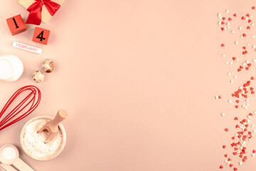 Frame of food ingredients for baking on Calming Coral background. Cooking flat lay with copy space. Top view.