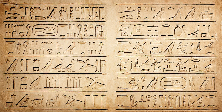 Old Egyptian hieroglyphs on an ancient background. Wide historical background. Ancient Egyptian hieroglyphs as a symbol of the history of the Earth.