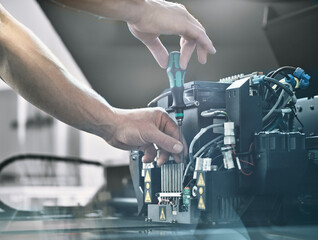 Technician fixing 3D printer with screwdriver at factory