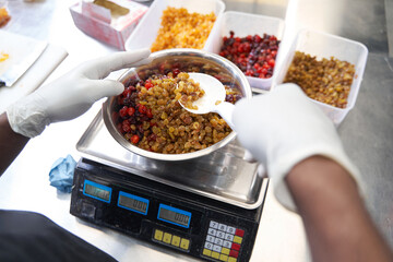 Professional cook preparing ingredients for baking at the kitchen