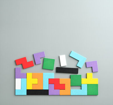 colorful wooden jigsaw puzzle on grey background with copy space , business background