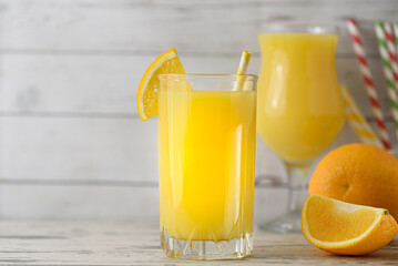 Full glass of orange juice close-up. Fresh orange juice on wooden table