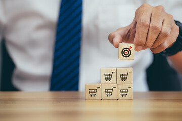 Man hands flips cube with icon target goal shopping cart symbol, sale volume increase make business...
