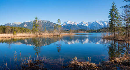 Fototapeta na wymiar beautiful moor lake Barmsee with view to Karwendel mountains, reflecting in the water
