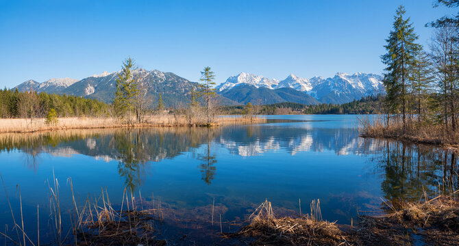 beautiful moor lake Barmsee with view to Karwendel mountains, reflecting in the water