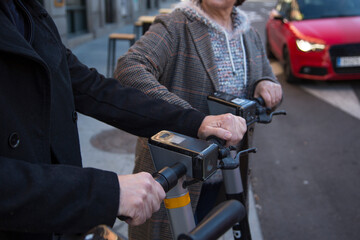 detail hands senior couple renting scooters