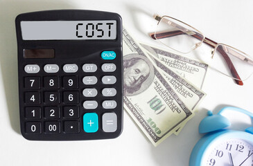 Calculator with the word cost on the display, next to dollars