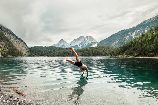 Tourist diving in Blindsee lake by Mieming Range, Tirol, Austria