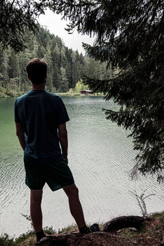 Man admiring Fernsteinsee lake and alpine hut, Ehrwald, Tirol, Austria