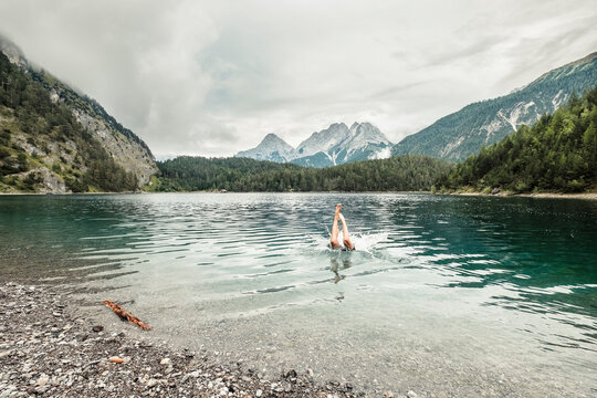 Man swiming in Blindsee lake by Mieming Range, Tirol, Austria
