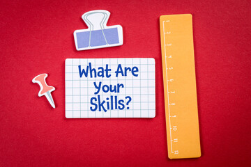 What Are Your Skills. Teaching and office items on a red background