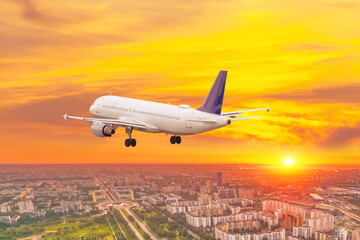 Airline airplane fly in sunset sky prepare to landing International airport.