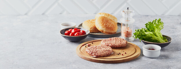 Raw veal mince Burger steak cutlets on wooden cutting board