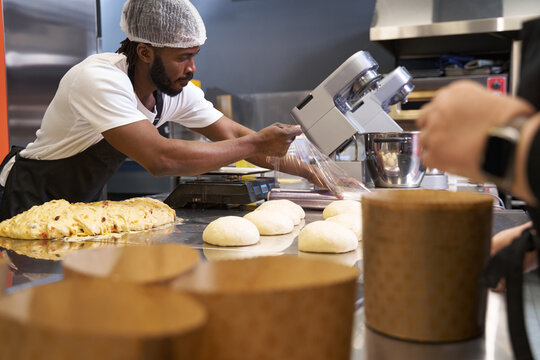Male in protective clothes working at the kitchen