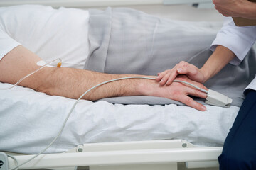 Physician monitoring patient oxygen saturation during intravenous therapy