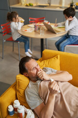 Obraz premium Diseased man coughing while lying on couch