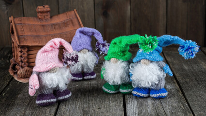 Bright handmade knitted toys, gnomes in a hat
