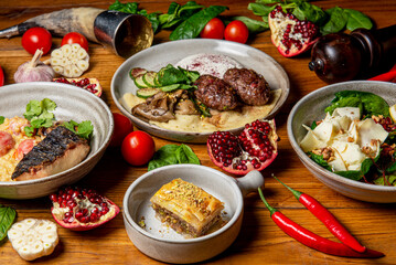Traditional Georgian cuisine dishes on the table. Side view. Flat lay. A lot of spices and vegetables around