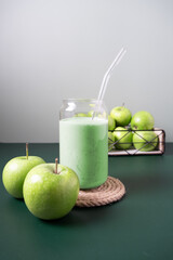 Blended apple smoothie with ingredients selective focus.