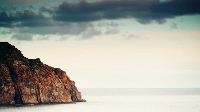 Clouds moving over mediterranean sea and rocky coast. Cabo de Moras seascape in Galicia Spain. Time lapse