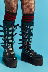 Gothic boots, studio shot isolated on blue background.