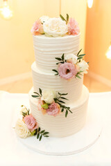 modern wedding cake decorated with flowers. lovely wedding cake