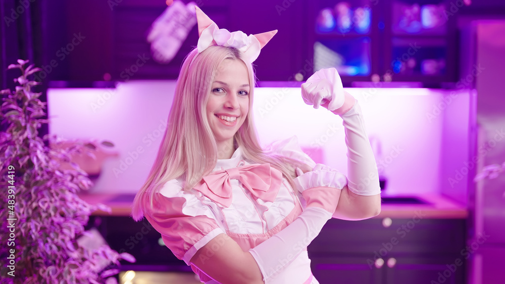 Wall mural portrait of cute blonde maid in pink uniform capable and strong gesture 4