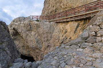 Fototapeta na wymiar Pedestrian bridge on the destroyed area of the tourist trail.