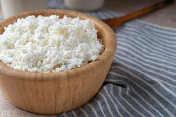 Traditional homemade cottage cheese in a wooden bowl