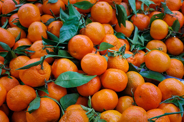 Piles of clementine fruit for sale on a market stall