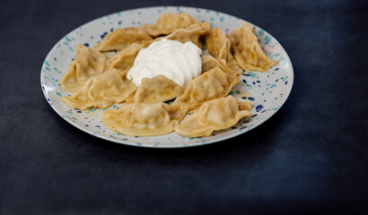 Tasty dumplings with sour cream