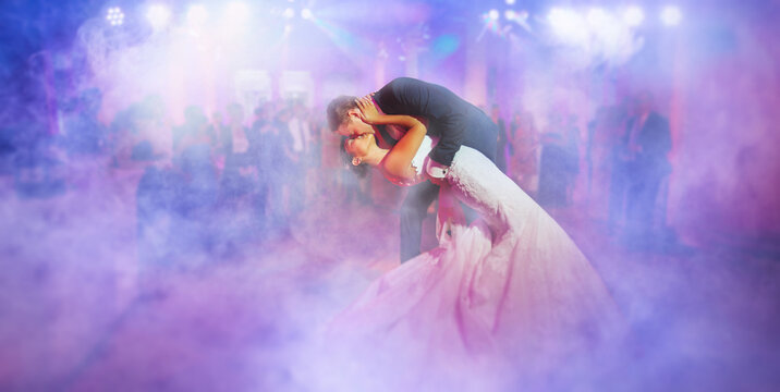 first dance - Elegant wedding by night. Groom kisses the bride in a waltz