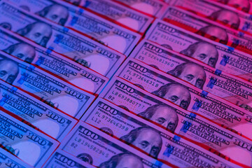Money background. Dollars lighted by blue and red. Financial market