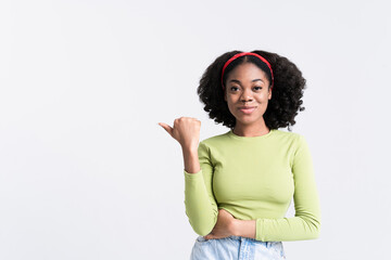 Young black woman smiling and pointing finger aside