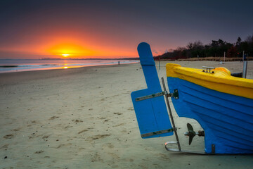 Fishing boat at sunrise on the Baltic Sea beach in Sopot. Poland