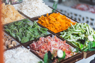 Close-up of beautiful rows of fresh dried fruit kiwi, papaya, mango, coconut.  Various dried fruit  on the market showcase