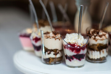 dessert buffet. assortment of sweets. catering service table. desserts garnished with nuts, jellies and berries. Preparing for holiday and decorating candy bar.