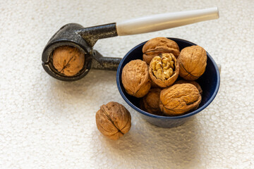 walnuts and nutcracker on a white background