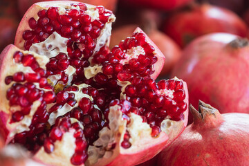 Close-up of bright fruits for background, texture. Red ripe pomegranates on display.