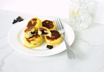 Syrniki, cottage cheese fritters with chocolate, minimalist style