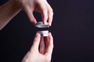 packaging of hand cream in female hands