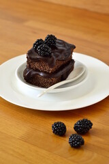 Chocolate zucchini cake with chocolate ganash and fresh blackberries, , vertical, copy space