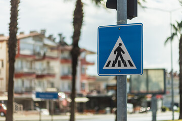 pedestrian crossing road sign  on a city background