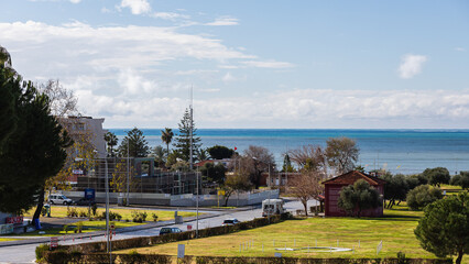 Landscapes on the city embankment on the shore of the Mediterranean Sea with street shops, green lawns and alleys