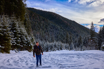 Fototapeta na wymiar a tourist in winter landscape in the mountains