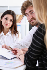 Group of people sit in office deliberate on problem