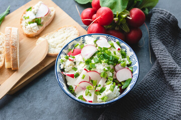 Cottage cheese with freshly cut chives and radish. Light nutritious breakfast