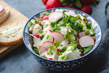 Cottage cheese with freshly cut chives and radish. Light nutritious breakfast