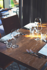 Empty glasses and cutlery on the table. Breakfast, dinner or lunch preparation in the restaurant or hotel.