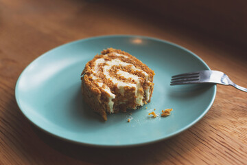 Half eaten dessert on the plate and fork. Time in cafe, sugar cut, diet concept. Copy space for your text.